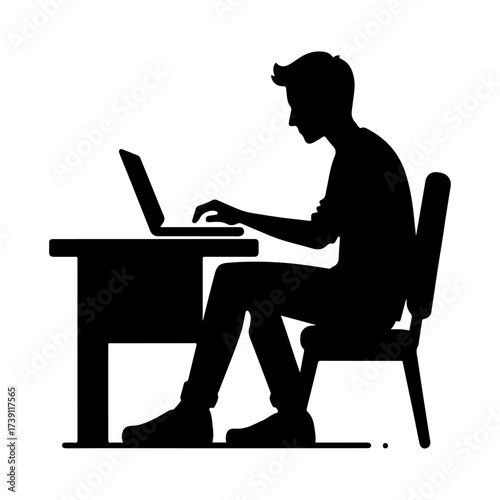 Silhouette of a man working on a laptop at a desk