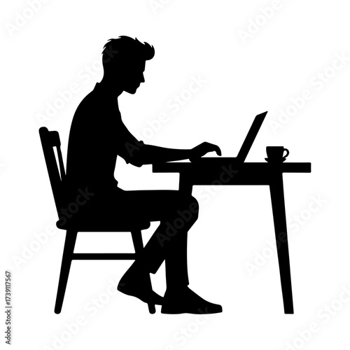 Silhouette of a man working on a laptop at a desk