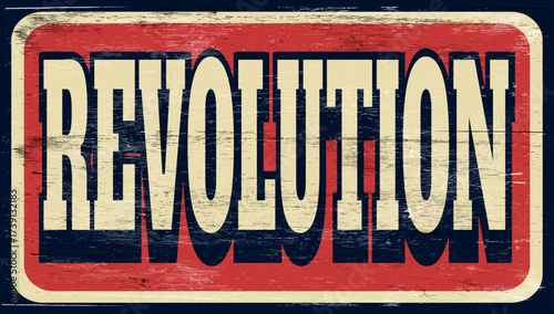 Aged and worn revolution sign on wood
