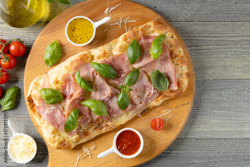 Traditional Roman pinsa with ham and basil.