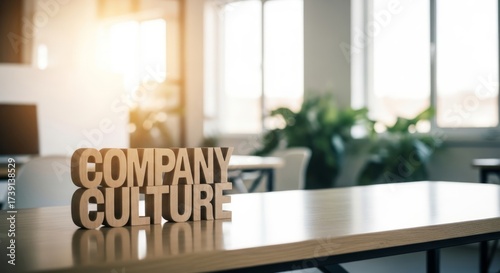 Wooden Company Culture sign on a modern office desk, bathed in sunlight. The bright and airy space evokes a sense of collaboration and positive work environment.