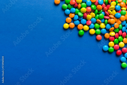 Mixed collection of colorful candy, on colored background. Flat lay, top view. frame of colorful chocolate coated candy