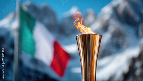 Olympic torch flame burning against italian flag and snowy mountains for milan cortina 2026 winter games