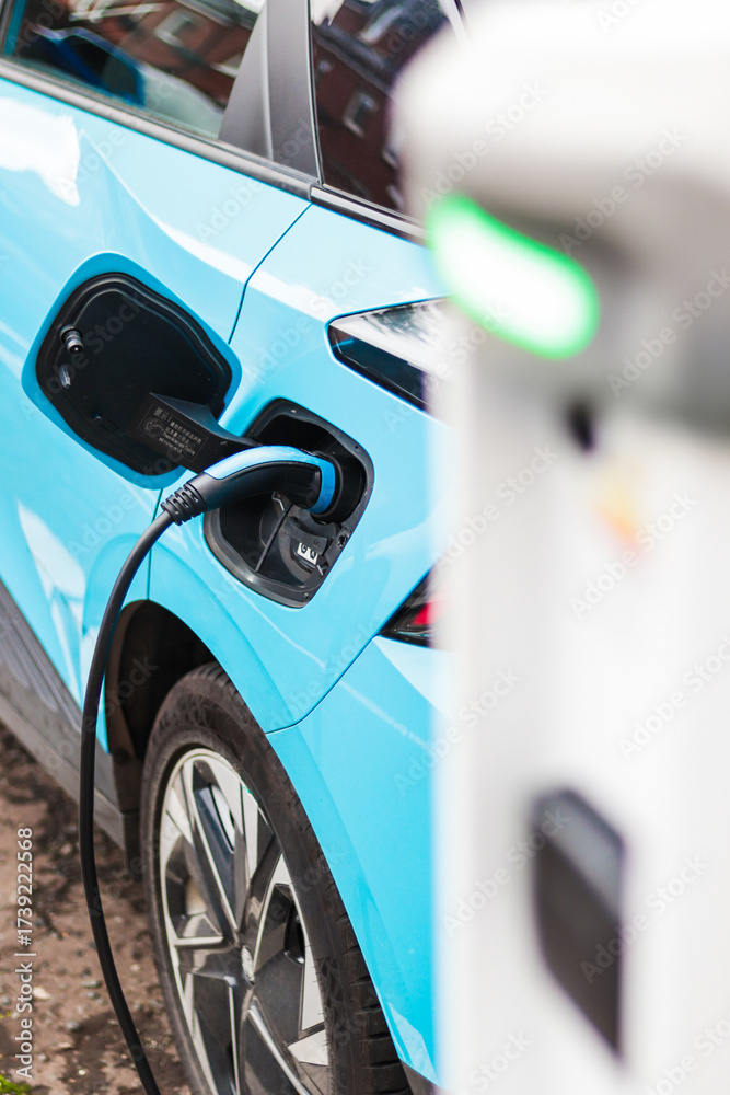 Fototapeta premium Blue Electric Car Charging at Station