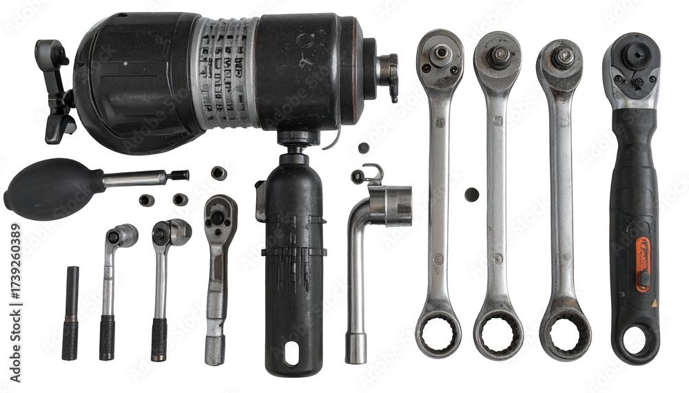 Fototapeta premium Various mechanical tools and components are arranged on a black background, showcasing an array of ratchets, sockets, and a large industrial instrument, emphasizing equipment and elements of...