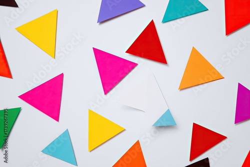 Free Download Vibrant array of colorful triangular shapes scattered against a clean white backdrop. Abstract design - GFXLoad