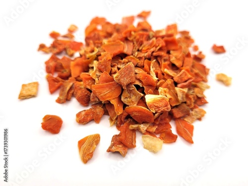 Pile of dried and sliced carrot on a white background
