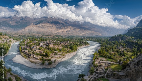 Mountain valley with river confluence and cloudy sky