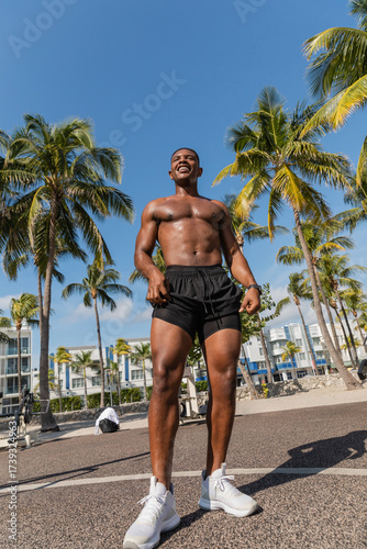 Muscular man enjoys a sunny workout session on the streets of Miami