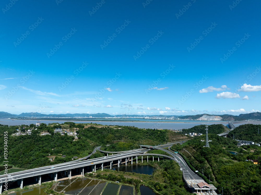 Fototapeta premium Aerial view of a multi layered highway interchange with vehicles and greenery