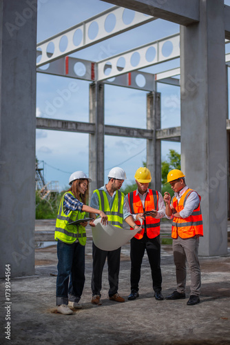 Engineers, architects and inspectors are working together to plan the strengthening of the structure of a large building.