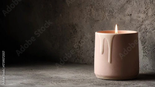 warm candle nestled in ceramic holder against rough concrete backdrop exuding tranquility