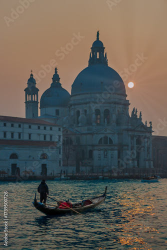 Gondolier in front of Santa Maria della Salute at sunset, Venice, Italy