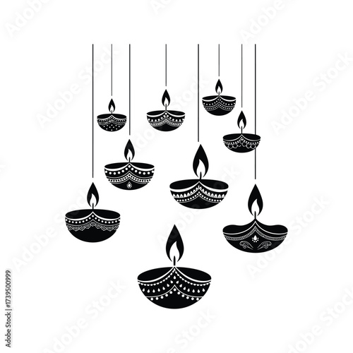 Decorative black diya lamps with intricate patterns hanging against a white background celebrating diwali