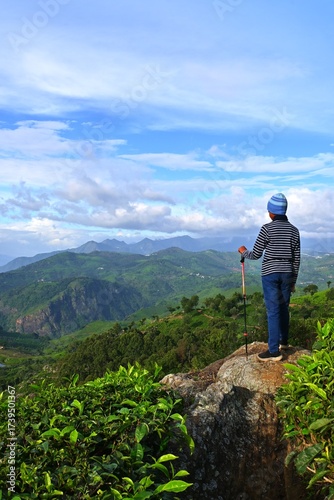 hiking in the mountains, boy standing hilltop watching mountains, Western ghats mountain range, India 