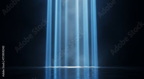 Mystical blue light beams shining from above onto reflective surface