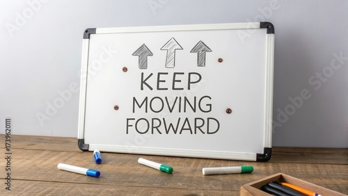 Whiteboard with Inscription on Wooden Table with Markers