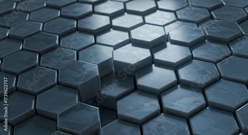 Abstract geometric background featuring a pattern of raised and recessed hexagonal shapes in shades of gray and blue.