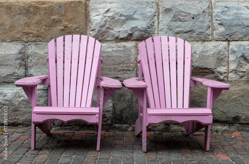 two light pink Muskoka chairs in the garden
