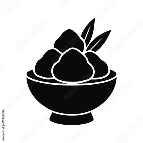 Fruit in a bowl with leaves.