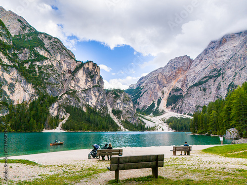 Lago di Braies or Lake Braies crystal blue lake with wooden rowing boats in Italian Dolomites. Mountain forest lake in Italian apls Dolomites South Tyrol. Mountain summit ridge. Glacier lake. 