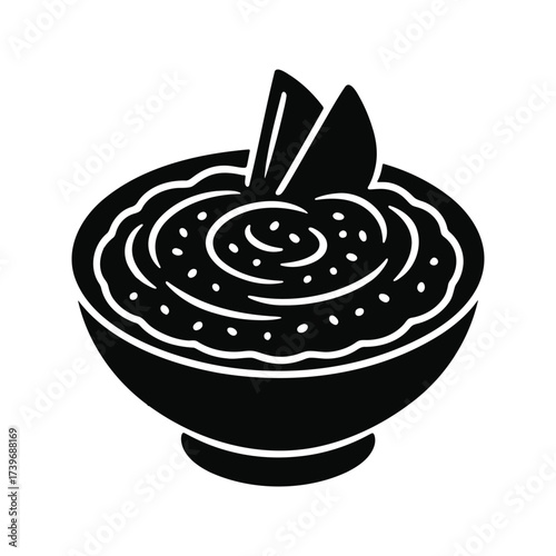 Bowl of food with garnish, possibly soup or dip.