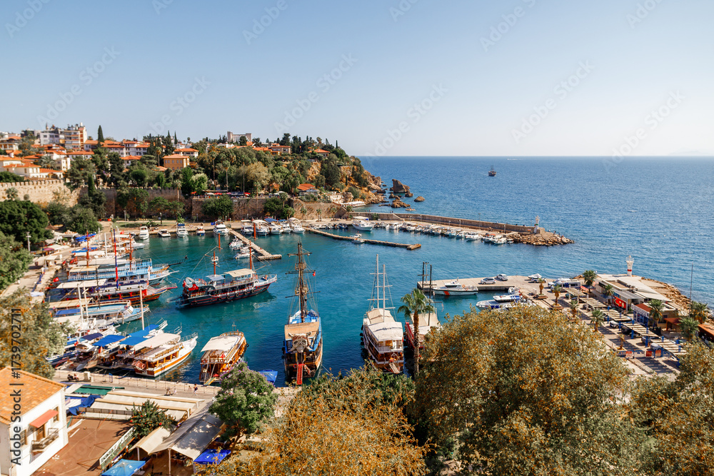 Obraz premium Port in the old town of Antalya or Kaleici in Turkey. Harbor with Boats and Hillside Town