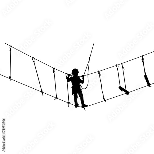 Young child traversing rope bridge at adventure park