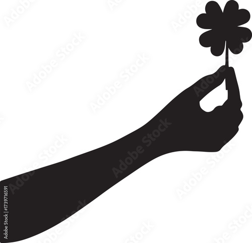 Silhouette of arm with hand holding a lucky four leaf clover