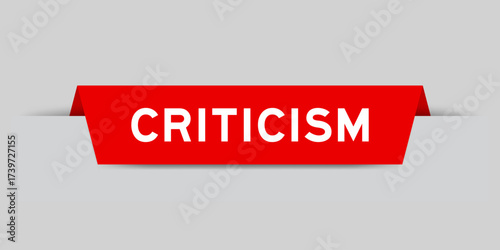 Red color inserted label with word criticism on gray background