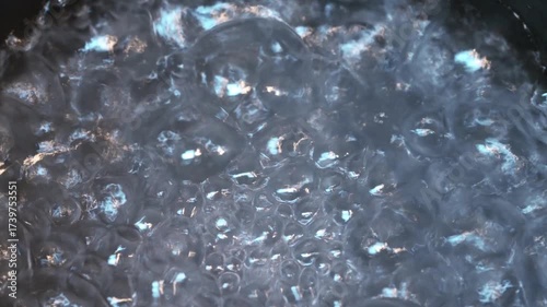 Close-up of water boiling with rising bubbles