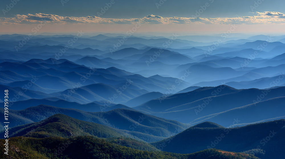 Obraz premium Misty blue mountains layered under a soft sky, symbolizing tranquility, depth, serenity, natural beauty, and peaceful landscapes in a dreamy atmospheric setting.