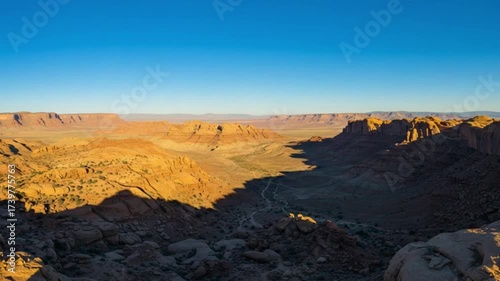 The view from the top of the cliff showing the sunset casts shadows on the cliff in the footage
