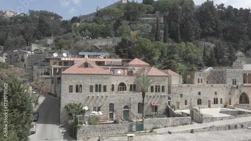Aerial view of the historic main square in Deir el Qamar, Lebanon, surrounded by traditional stone buildings, houses, and cultural landmarks. 