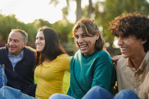 Group of diverse age people having fun together at city park - Multi generational friends, community and lifestyle concept