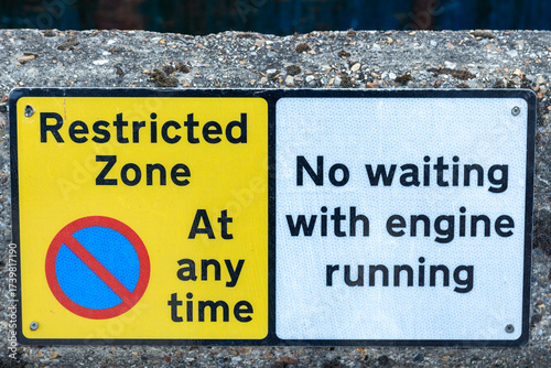 No parking sign, restricted parking zone. No waiting with engine running sign