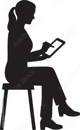 Silhouette of a woman sitting on a stool using a digital tablet with a stylus pen for drawing or writing