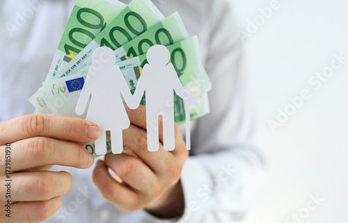 Hands holding paper figures...