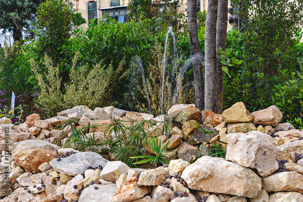 custom made wallpaper toronto digitalTextured stone and boulder arrangement with native plants forms dry garden exhibit within urban plaza under soft spring sky