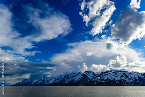 View of the snow-capped mountains in the clouds near the lake Gren Titon, USA.