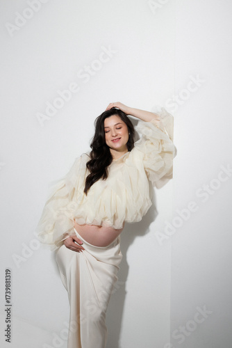 Pregnant Woman in Elegant White Outfit