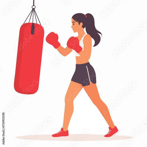 A woman in boxing gloves practices punches on a red punching bag, demonstrating fitness and strength.