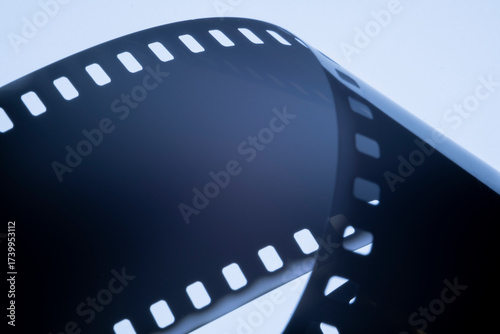 Film strip template with three blank or empty frames, developed 135 type or 35mm film placeholder on white, real film grain