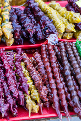 A colorful display of traditional Georgian churchkhela, a popular sweet made from nuts strung together and coated in thickened grape juice