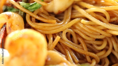 Italian spaghetti with delicious shrimp and squid, spaghetti in a white plate.