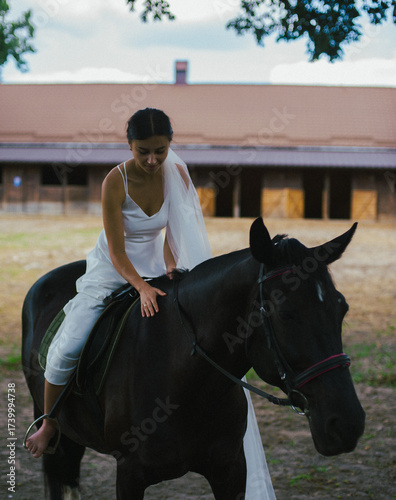 Bride riding horse in wedding dress outdoors