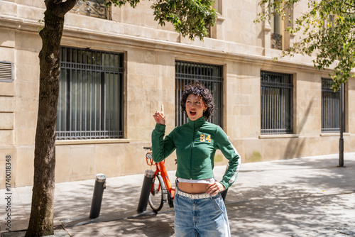 Young woman pointing up having an idea in the city