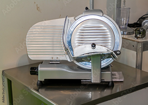 Fotografie Electric slicer is a tool used to slice meats, sausages, cheeses and other deli