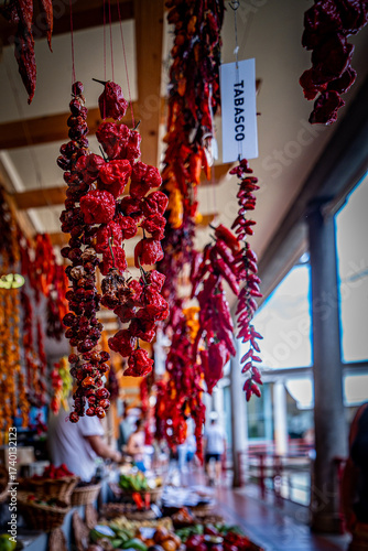 Close-up of a hanging bunch of dried red chili peppers at Mercado dos Lavradores, the famous central market of Funchal, Madeira