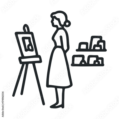 Female artist painting in studio with canvas and artwork on display